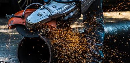 Pipe being cut with sparks